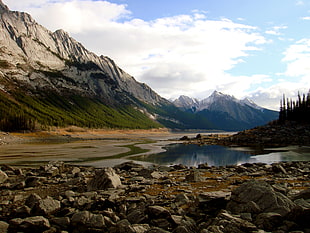 body of water surrounded by mountain and rock