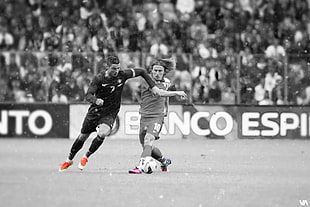 greyscale photo of two male soccer players on football field