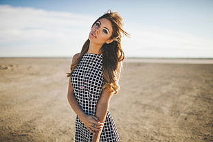 woman in black and white checkered sleeveless dress