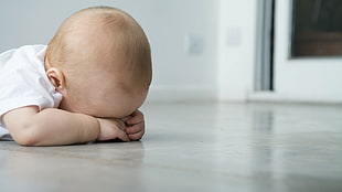 infant lying on floor HD wallpaper