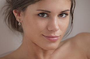 woman wearing silver-colored stud earrings