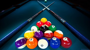 billiard balls and sticks on table