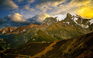 green mountain under white clouds