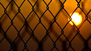 silhouette of cyclone fence