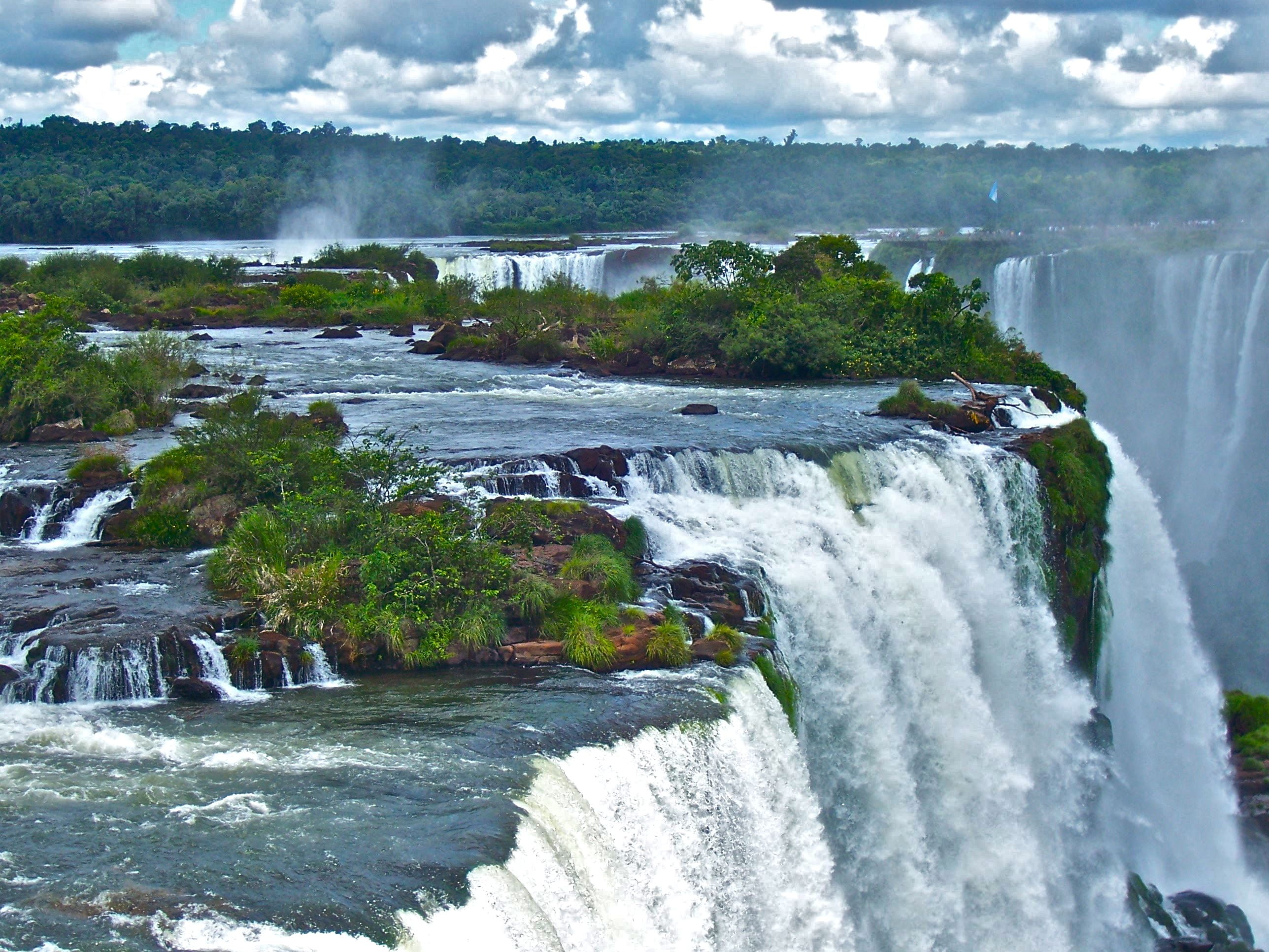 landscape aerial photography of waterfall with green trees during daytime