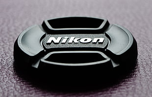 black Nikon camera lens cap
