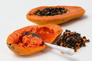 orange papaya fruit with stainless steel spoon