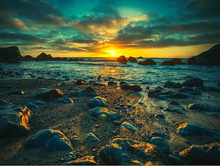 landscape photography of stone near seashore