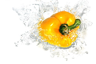close up photo of a yellow bell pepper on water