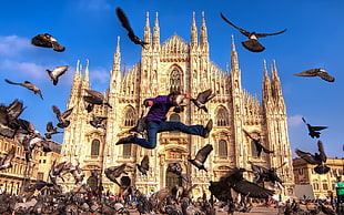 timelapse photography of person jumping with Milan, Cathedral background