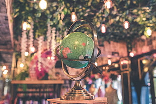 green and brown armillary sphere HD wallpaper