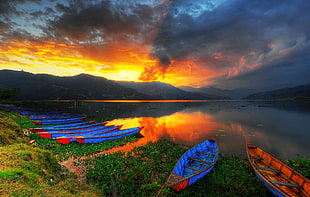 landscape photography of canoes near lake during sunset, phewa lake, pokhara, nepal