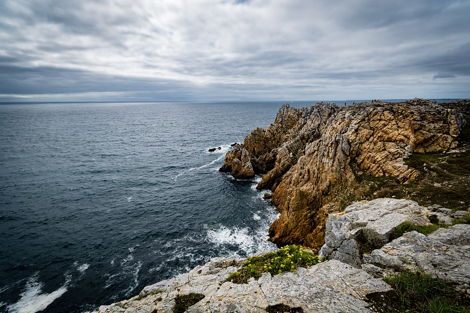 brown rock formation near sea HD wallpaper
