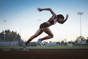 woman running on track field HD wallpaper