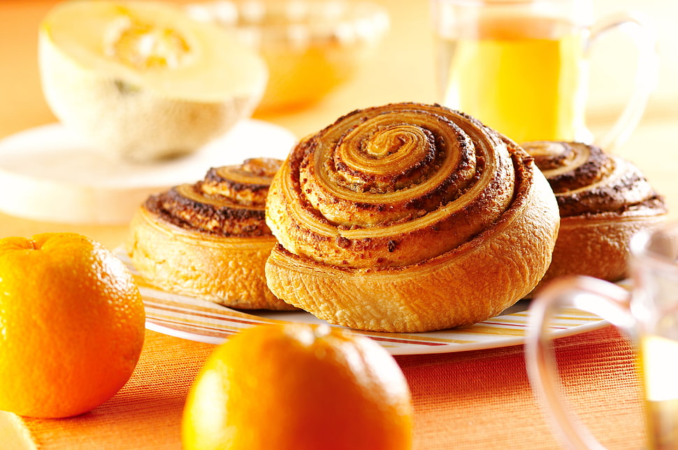 three brown rolled cinnamon breads HD wallpaper