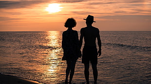 silhouette of man and woman in the beach