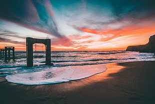 landscape photography of body of water under blue and red sky