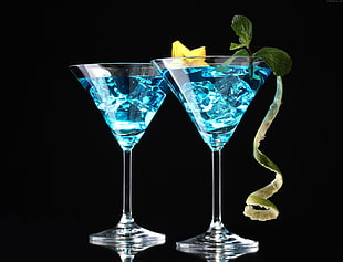 two clear martini glasses with blue liquid