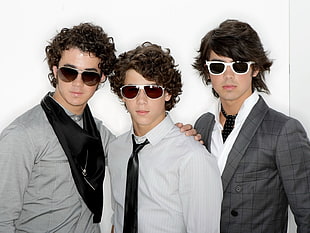 three man wearing sunglasses and suit jackets photo