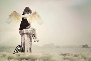 girl with wings sitting on wooden stand above clouds bed