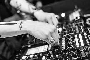 grayscale and selective focus photograph of DJ mixer