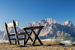 brown wooden table and bench bear mountains during daytime