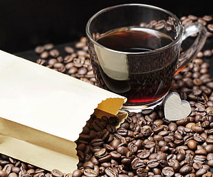 coffee beans with glass cup filled with coffee