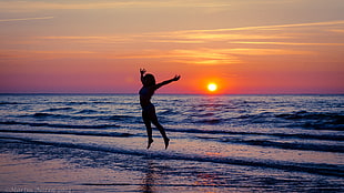 silhouette photo of woman on seashore