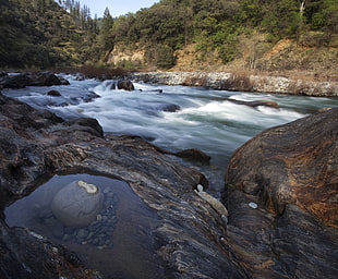 river surrounded with rocks HD wallpaper