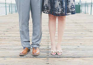 man and woman standing on bridge during daytime