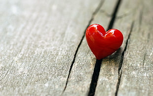 depth of field photography of heart shape decor on brown surface