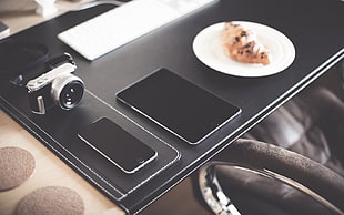 space gray iPhone 6 beside space gray iPad and point and shoot camera