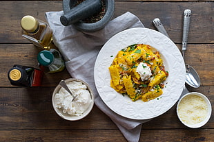 cooked food served on white ceramic plate with utensils