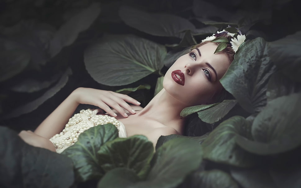 woman laying on green leaf plants HD wallpaper