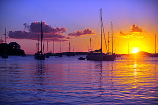boat on lake during sunset HD wallpaper