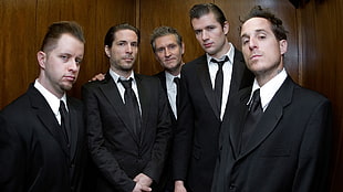 five men wearing black notched lapel suit jackets