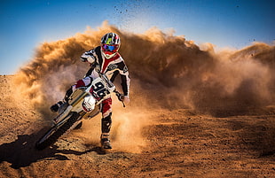 motorcross rider on desert during daytime photo