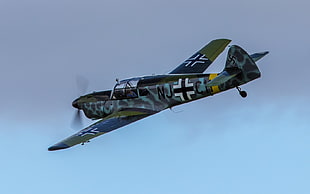 photo of green, gray, and black Warplane