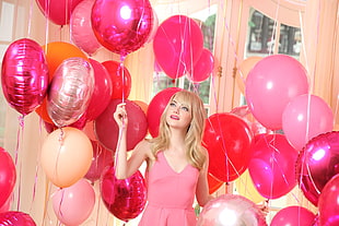 woman wearing pink tank top standing near pink balloons