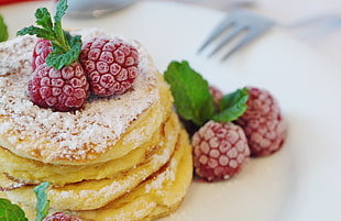 hot cakes topped with red raspberries