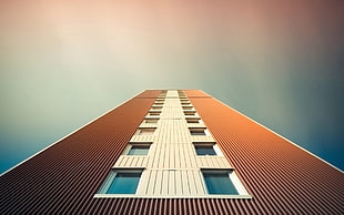low-angle photography of brown and beige high rise building