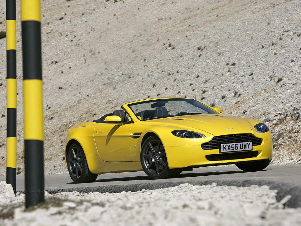 yellow convertible coupe parked on concrete road HD wallpaper