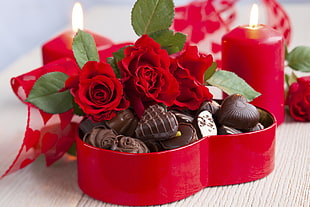 red petaled flowers with chocolates