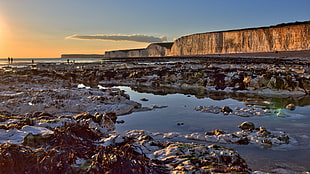 rock formation near on body of water during sunset photography, birling gap HD wallpaper