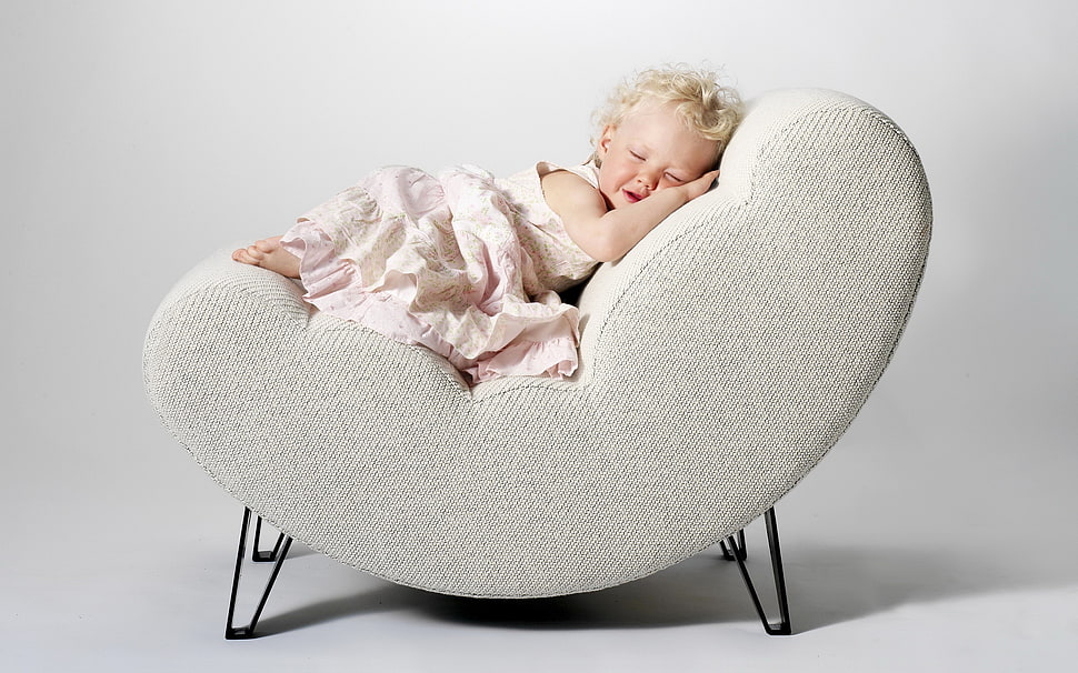 baby girl lying on gray chair HD wallpaper