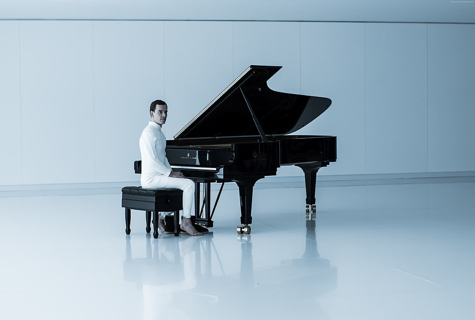 man in white dress shirt playing black grand piano with white background HD wallpaper