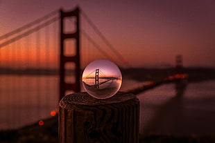 depth of field photo of crystal ball in distance of brooklyn bridge HD wallpaper