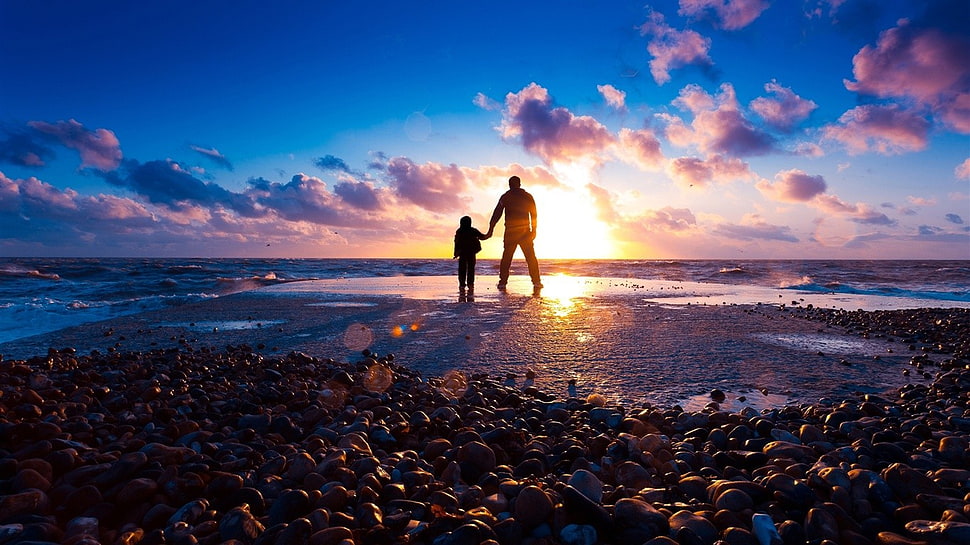 silhouette photo of man and boy, sea, stones, clouds, nature HD wallpaper