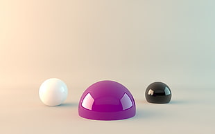 three white, black, and purple marbles on brown surface