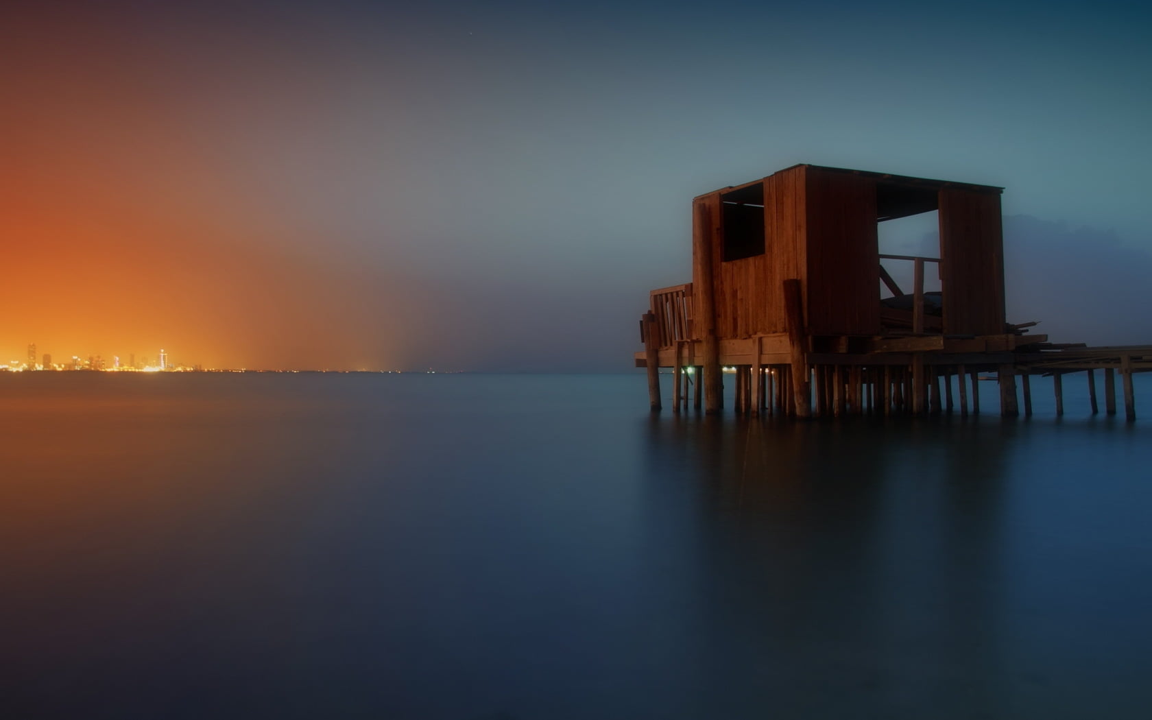 landscape photo of brown wooden shed on sea dock